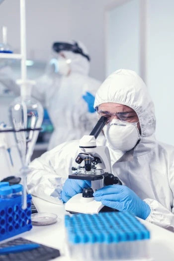 clinical research assistant, working with microscope
